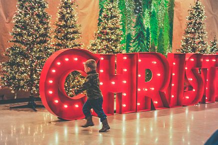 Child with Christmas Sign